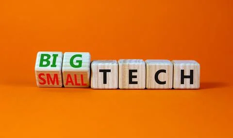 Big or small tech symbol. Turned wooden cubes and changed concept words small Stock Photos