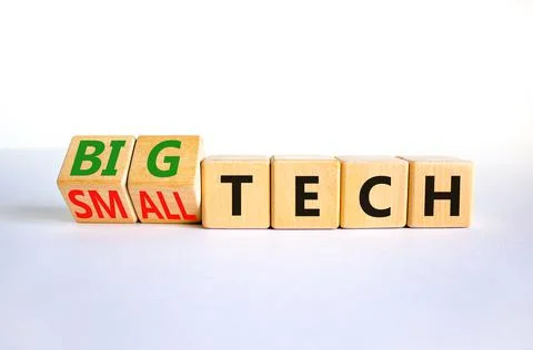 Big or small tech symbol. Turned wooden cubes and changed concept words small Stock Photos