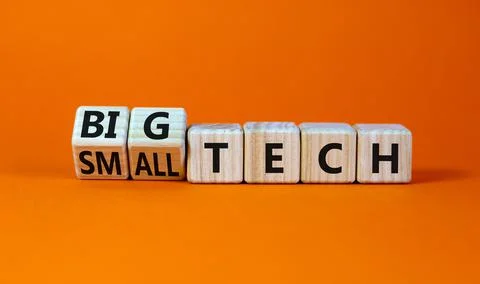 Big or small tech symbol. Turned wooden cubes and changed concept words small Stock Photos