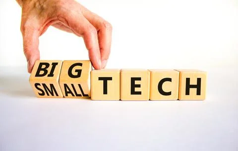 Big or small tech symbol. Businessman turns wooden cubes and changes concept  Stock Photos