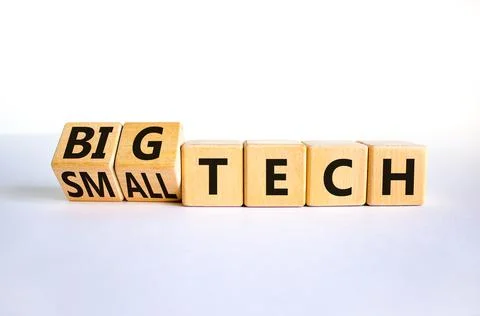 Big or small tech symbol. Turned wooden cubes and changed concept words small Stock Photos