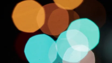 Big orange and light blue bokeh with fading red and green spots with headlights Stock Footage 83800235
