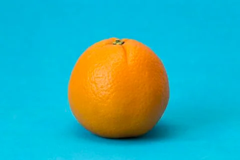 Big  orange on a blue background Stock Photos