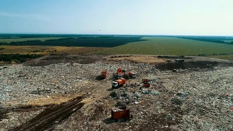 Big Orange Garbage Truck Garbage In Huge Garbage Dump. Working equipment at the 動画素材 114497233