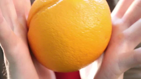 Big orange in human hands Stock Footage 65014701