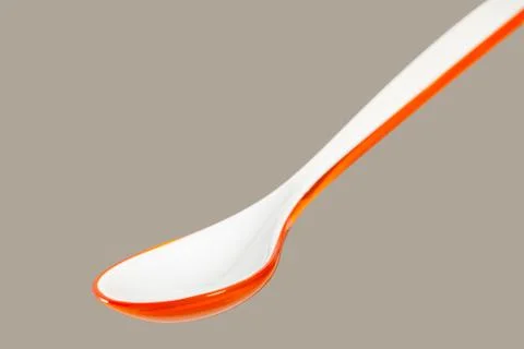 Big orange plastic spoon Stock Photos