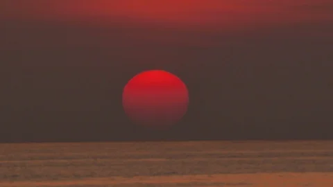 Big orange sun falling down into the deep sea in the golden twilihgt evening  Stock Footage 126754181