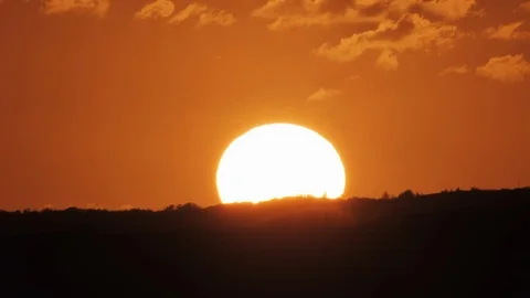 Big Orange Sun - Sunset Time lapse 4k Telephoto Closeup - Sun Setting, Nature Stock Footage 125050135