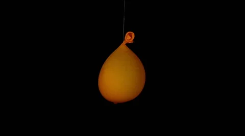 Big orange water balloon exploding Stock Footage 56813011