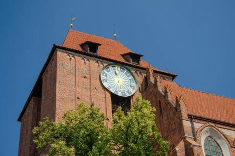 Big outside ancient clock on the Old Town Hall in Torun, Poland. Low angle vi Stock Photos