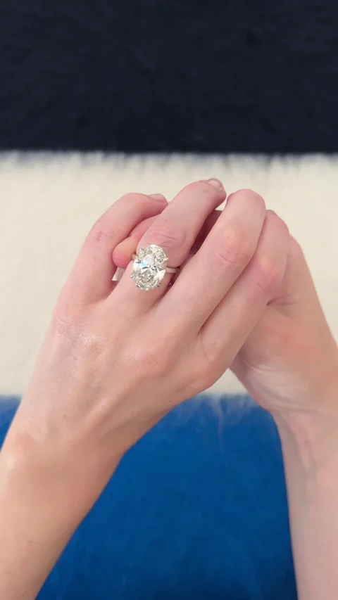Big oval diamond engagement ring shown on hand minimal background 스톡 동영상 328251104