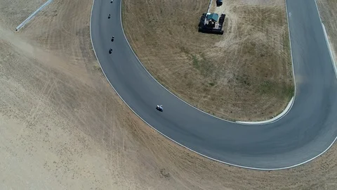Big pack of cyclists come around a sharp turn Stock Footage 126739925