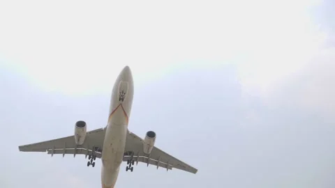 A big passenger airplane with big propellers flying and taking down Stock Footage 153048532
