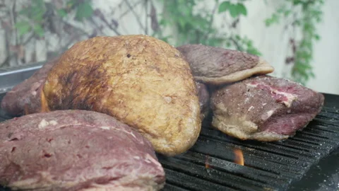 Big pieces of steak on a flaming grill. 4k. Stock Footage 234644341