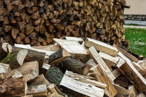Big pile of split logs piled in a heap near the woodpile Stock Photos