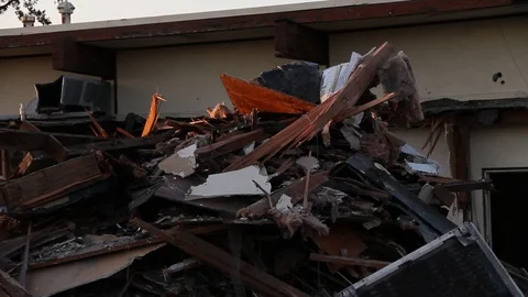 Big pile of trash in front of torn down building Stock Footage 95109641