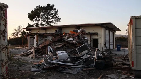 Big pile of trash in front of torn down building between dumpsters Stock Footage 95114556