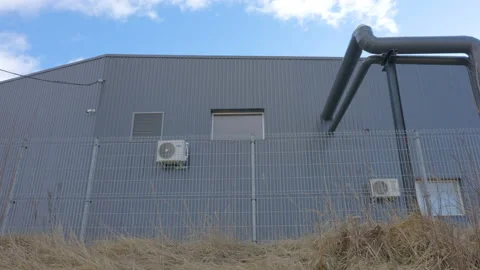The big pipes outside the big building in Estonia Stock Footage 150405232