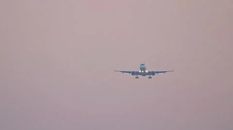 Big plane landing at sunset sky, flying airplane on red sunrise sky 스톡 동영상 65664493