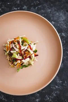 Big plate with small amount of salad in the centre, dieting and calorie restr Stock Photos