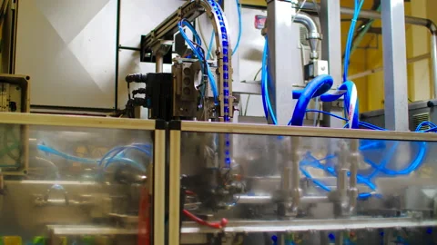 A big pneumatic packing machine with blue pipes automatic work on modern factory Stock Footage 150517484