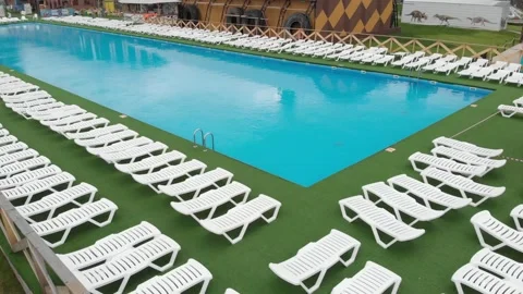 Big pool shut due to coronavirus COVID-19 lockdown. Blue pool. water, empty Stock Footage 131444592