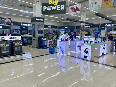 Big Power electronics department featuring smartphone brand booths inside Stock Photos