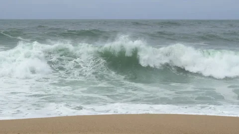 Big, powerful waves breaking on the sea shore on sandy beach in winter. 動画素材 274176305