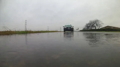 A big puddle and a car Stock Footage 69137623