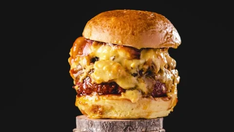 Big pulled pork and beef burger with many cheese and bbq sauce rotating con.. Stock Footage 236321338