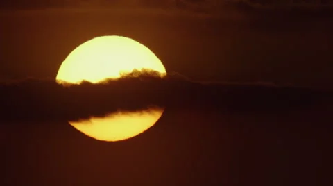 Big radiating glowing sun sunset over ocean close up telephoto real time scenery Stock Footage 48731559