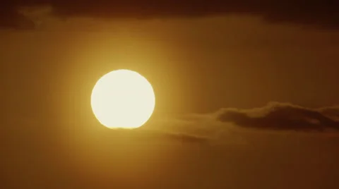 Big radiating glowing sun sunset over ocean close up telephoto real time scenery Stock Footage 48733637