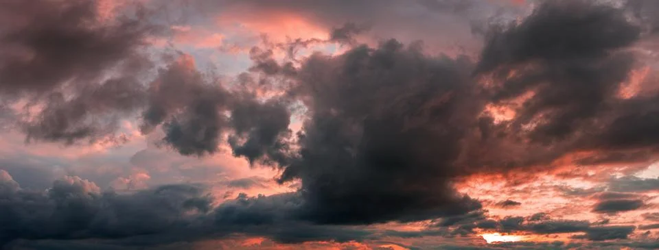 Big rain clouds at sunset Stock Photos