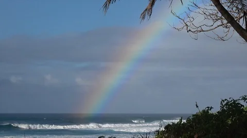 Big Rainbow over the ocean in Hawaii. Rolling waves on Oahu North Shore Stock Footage