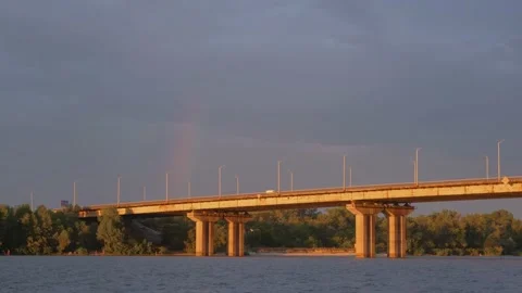 Big rainbow over the old bridge. Road bridge across the river. Rainbow over the Stock Footage 220326392