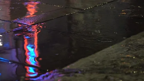 Big raindrop causes a big splash in a puddle Stock Footage 295103794