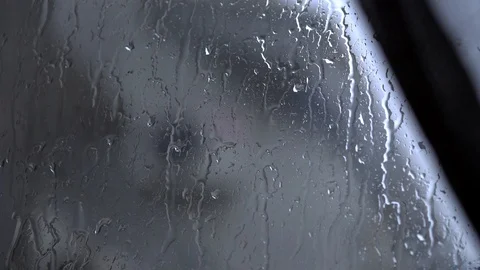 Big raindrops are pouring down the window Stock Footage 129895230