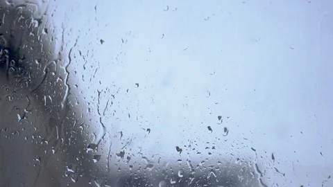 Big raindrops are pouring down the window Stock Footage 129895257