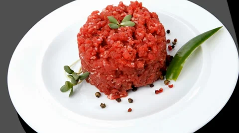 Big raw hamburger cutlet with sprouts and chili pepper over black 库存影片 36771251