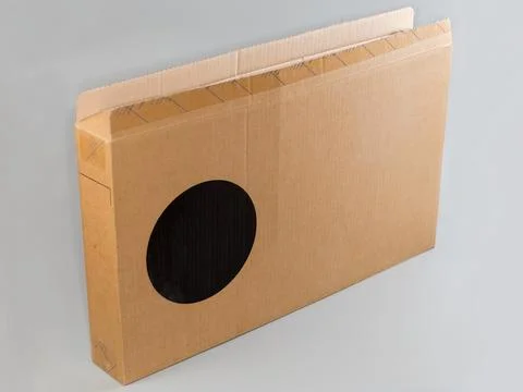 Big rectangular flat kraft cardboard box on a gray background Stock Photos