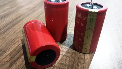 Big red batteries on the table Stock Photos