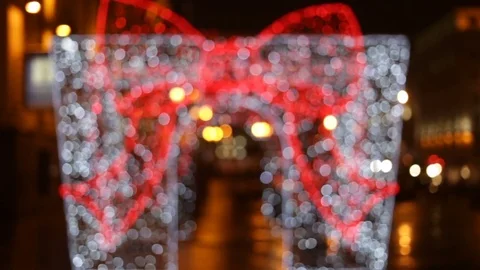 Big red bow Christmas light out of focus. Outdoors, real time, artificial lighti Stock Footage 83249328