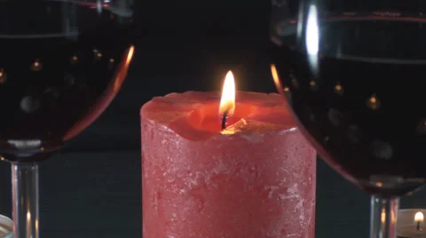 Big Red Candle And Two Glasses Of Wine Unfocused Close-Up Stock Footage 34470491