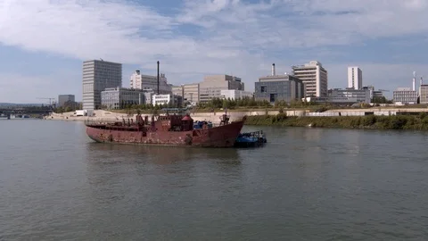 A big red crane preparing an old ship for repairs at the shipyard Stock Footage 120987248