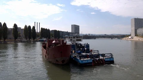 A big red crane preparing an old ship for repairs at the shipyard Stock Footage 120987350