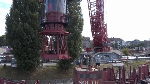 A big red crane preparing an old ship for repairs at the shipyard Video stock 120988292