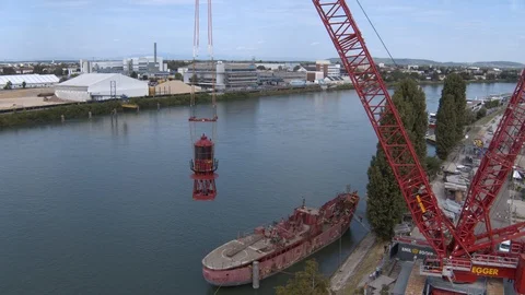 A big red crane preparing an old ship for repairs at the shipyard Stock Footage 120988691