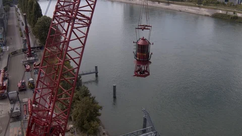 A big red crane preparing an old ship for repairs at the shipyard Stock Footage 120988864
