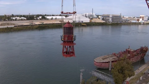 A big red crane preparing an old ship for repairs at the shipyard Video stock 120988938