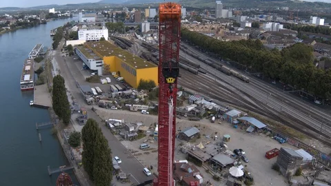 A big red crane preparing an old ship for repairs at the shipyard Stock Footage 120989031